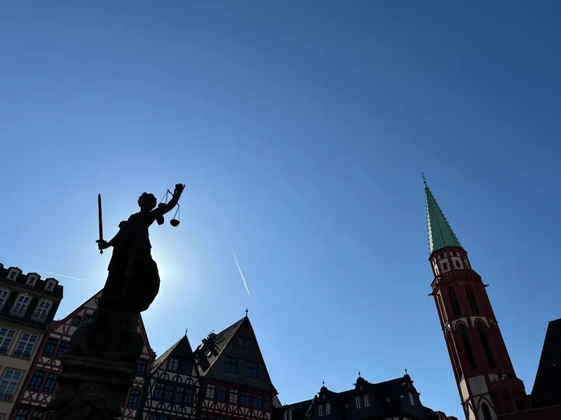 English-speaking guide leading a small group past the Römer old town hall on a frankfurt city tour in Frankfurt am Main